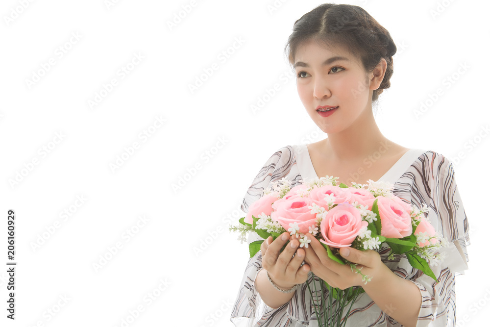 Portrait of young asian woman holding bouquet of flowers in her hands and smile on white background. Free from copy space. Portrait of young asian woman holding bouquet of flowers in her hands and smile on white background. Free from copy space.
