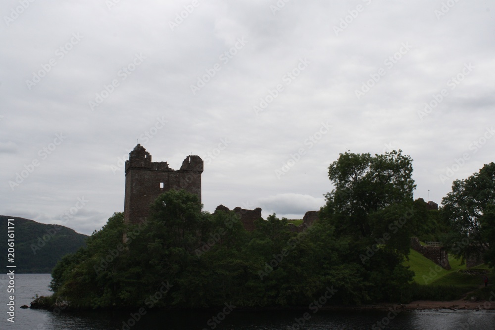 Ancient Tower ruins on coast of Loch Ness under cloudy skies