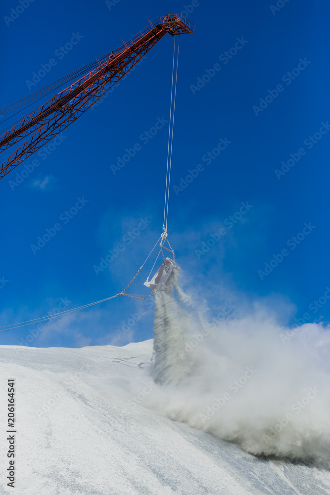 The bucket of the large quarry excavator is dumping waste products into the dumps The bucket of the large quarry excavator is dumping waste products into the dumps