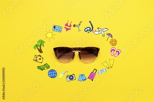 Sunglasses and Icons in Style. Travel and Vacation on a Yellow Background. Concept of Travel and Holidays. Flat lay, top view