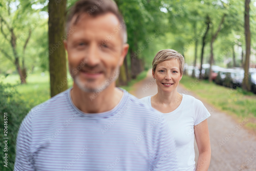 Middle-aged couple walking along a country road
