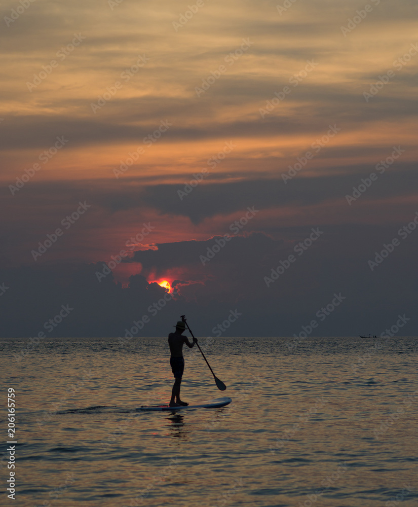 Sunset at the sea. Sup boarding.