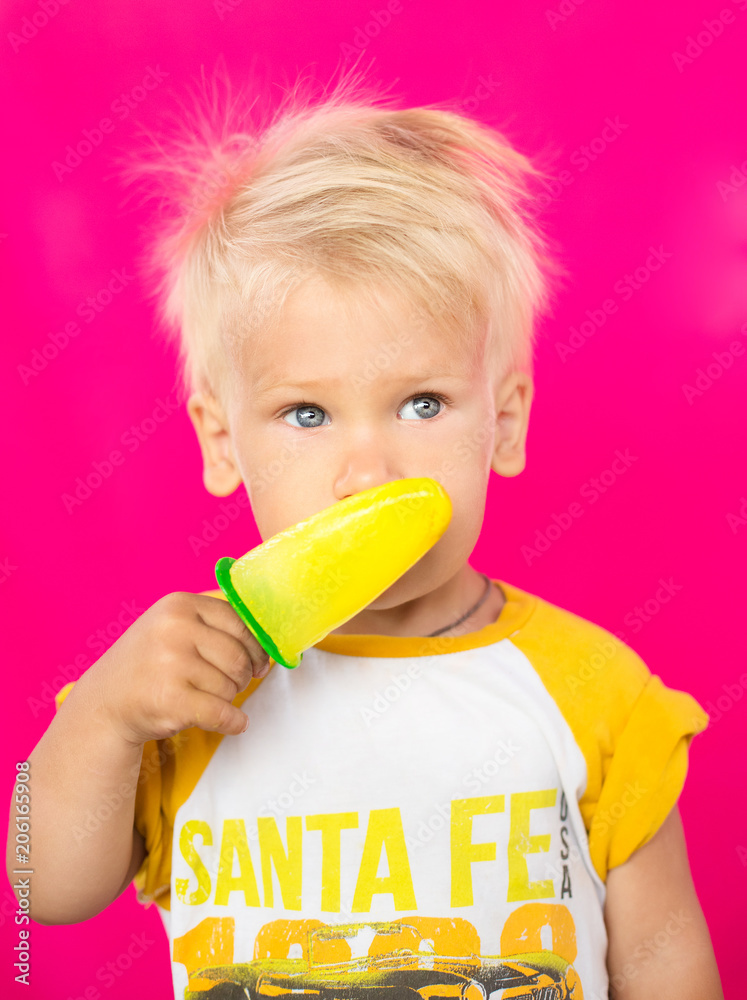 kid eating tasty ice cream on pink background kid eating tasty ice cream on pink background