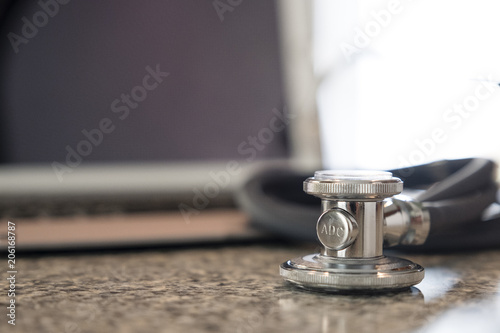 Stethoscope on keyboard countertop ready for use and data entry by medical professional
