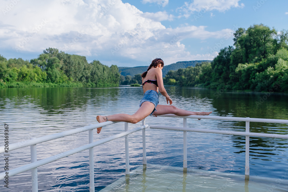 Fototapeta premium Young woman doing splits
