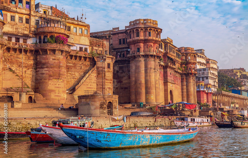 Historic Varanasi city with with ancient architecture along the Ganges river ghat as viewed from a boat. Varanasi is located in the state of Uttar Pradesh India. photo