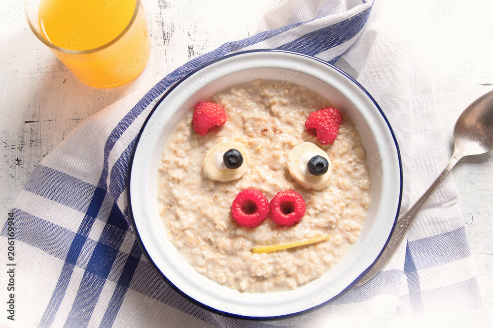 Oatmeal porridge with fruits for kids breakfast