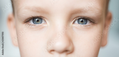 Closeup of beautiful boy eye. Beautiful grey eyes macro shot.