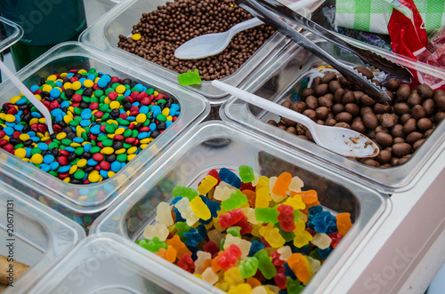 A sample of several candies in plastic containers photo