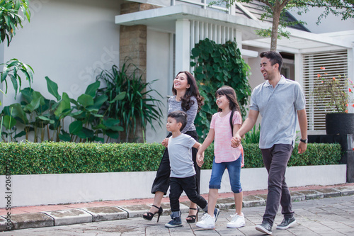 Fototapeta young happy asian family walking together
