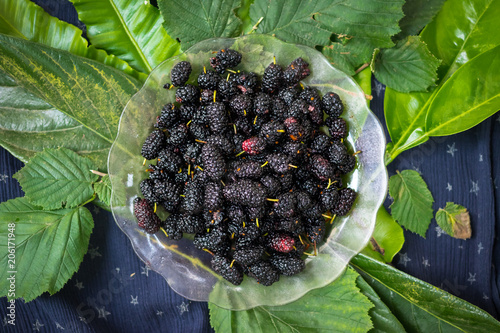 Black mulberry berries on wooden board. Organic farm sweet fruits of Georgia region. Sweet, juicy, delicious with antioxidant. Raw vegan vegetarian healthy food