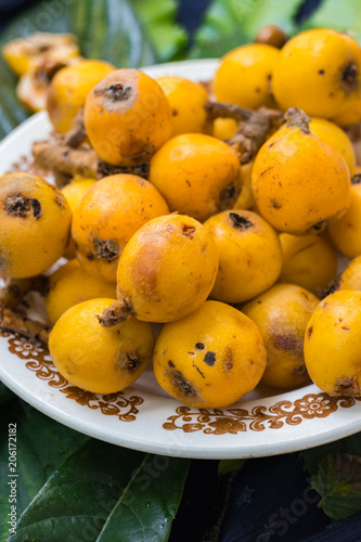 Fresh ripe mushmula or loquat fruit. Good for breakfast and desserts. Evergreen subtropical tree orange sweet and juicy fruit widely spread in Georgia, Japan, Korea, Spain and other asian countries. photo