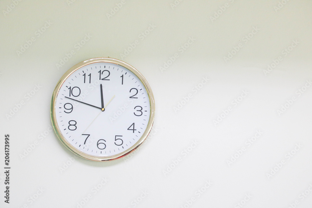 Clock around with gold and silver circles on cement wall. Clock around with gold and silver circles on cement wall.
