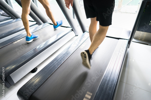 Gym treadmill closeup with man legs running. Concept for exercising, fitness and healthy lifestyle © Hanoi Photography