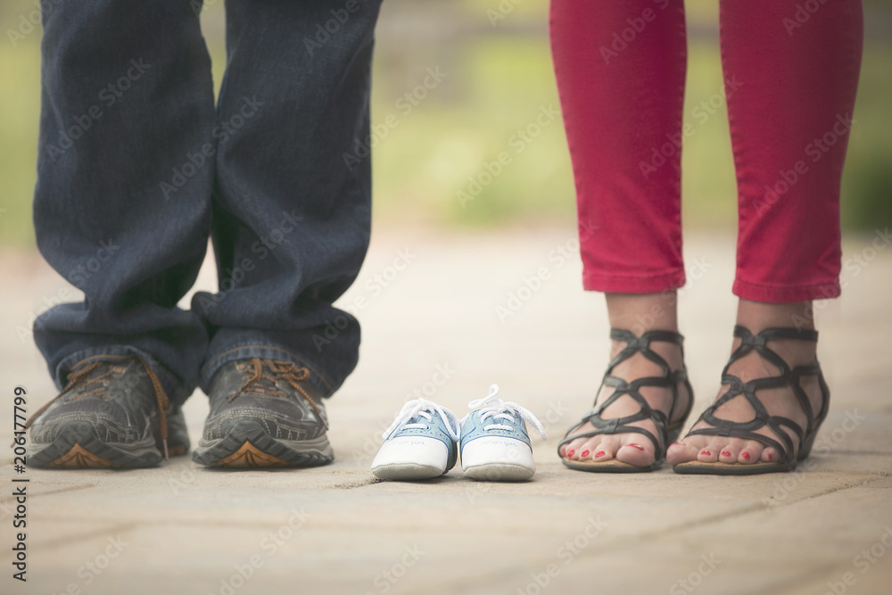 baby boy photo announcement with shoes of expecting parents