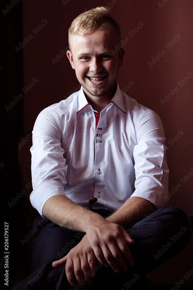 Portrait of smiling businessman on dark background
