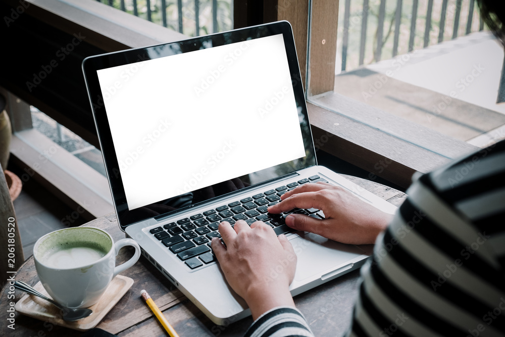 Woman hands typing on laptop keyboard with white blank screen with copy space for your advertising content. Woman hands typing on laptop keyboard with white blank screen with copy space for your advertising content.