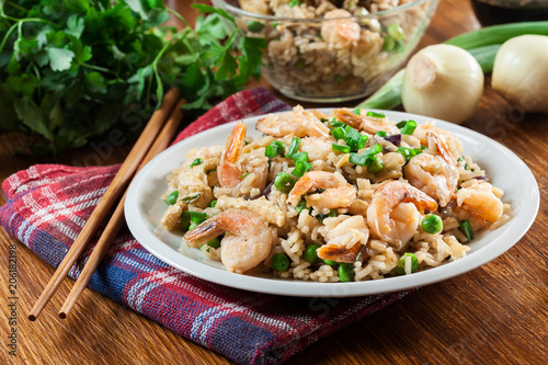 Fried rice with shrimp and vegetables served on a plate photo