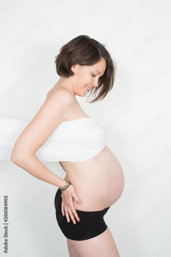 Portrait of a beautiful pregnant woman in white chiffon shawl on her breasts Portrait of a beautiful pregnant woman in white chiffon shawl on her breasts