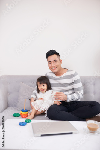 Father and daughter playing with bricks