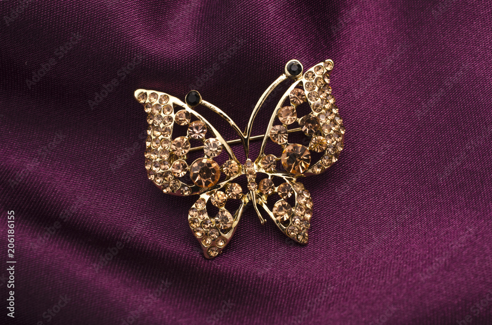 brooch butterfly with diamonds isolated on silk brooch butterfly with diamonds isolated on silk
