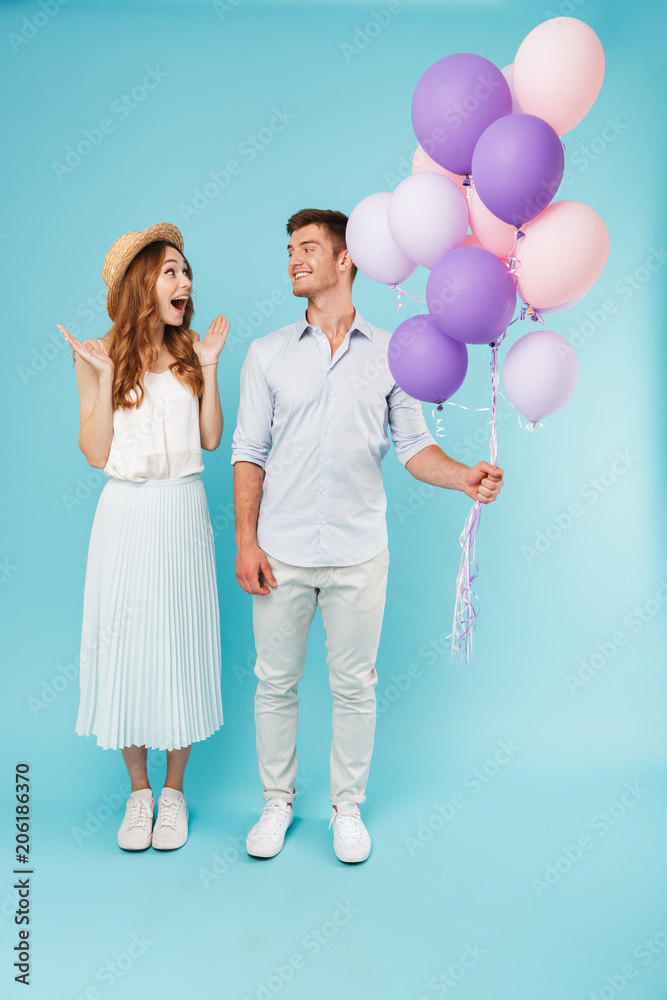 Happy caucasian loving couple holding balloons. Happy caucasian loving couple holding balloons.