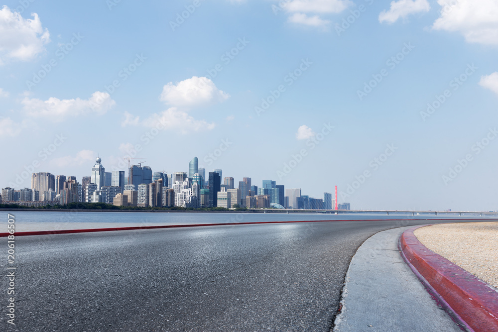 cityscape of modern city from empty asphalt road