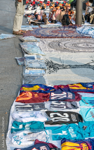 Photography BARCELONA - MAY 10, 2018: Soccer shirts sold on a market