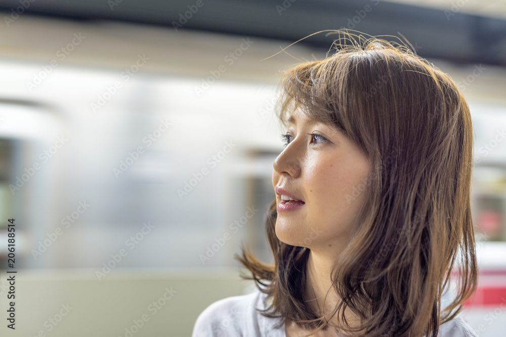 Happy asian girl waiting subway train Happy asian girl waiting subway train