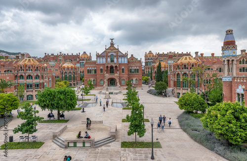 BARCELONA, SPAIN - MAY 12, 2018: People visit Recinte Modernista de Sant Pau. The city attracts 10 million tourists annually photo