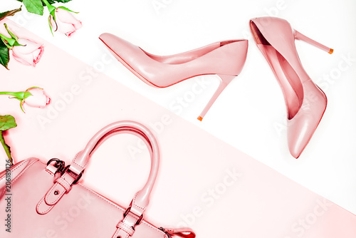 Pair of beige nude women's high-heeled shoes with handbag on a white background top view, flat lay, fashion concept