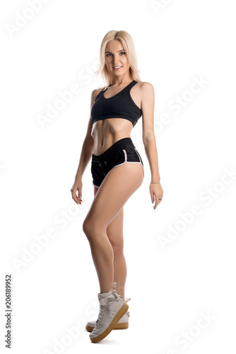 Slim fitness trainer in sportswear isolated shot