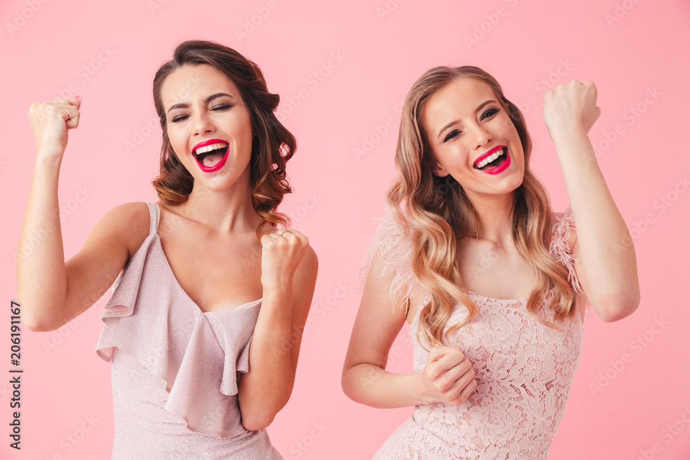 Two cheerful women in dresses rejoices and screaming together Two cheerful women in dresses rejoices and screaming together