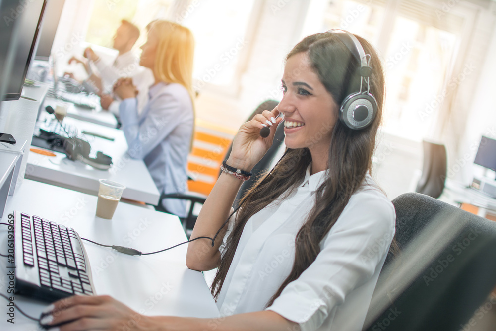 Customer service operator woman with headset working on computer at office Customer service operator woman with headset working on computer at office