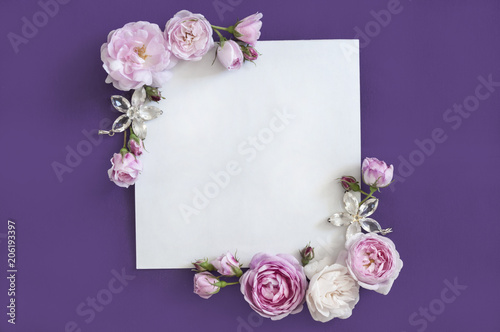 pink roses on a purple background, place for an inscription