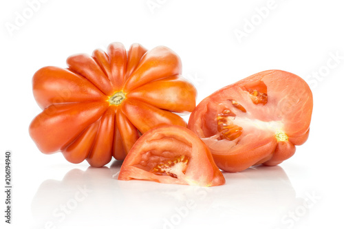 Sliced beef tomatoes collection (one whole flower shape section half and a slice) isolated on white background big ripe red flesh with seeds.