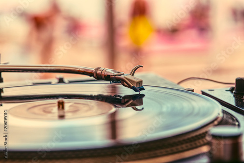 Record and turntable close-up on blurred background photo