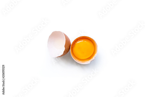 fresh brown organic chicken egg broken with yolk and egg white isolated on white background. Horizontal composition. Top view