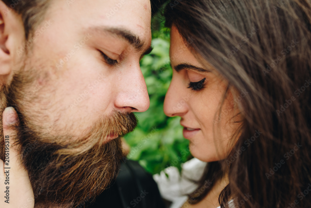 Fototapeta premium Concept of love relationship. Lovely happy couple. Amazing beautiful woman and handsome man. Romantic bearded boy and girl outdoor together. Man and girl are happy and enjoy each other.