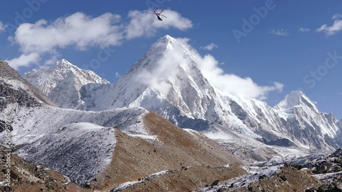 Helicopter flight over the Solu Khumbu valley towards the base camp of the Everest peak. photo