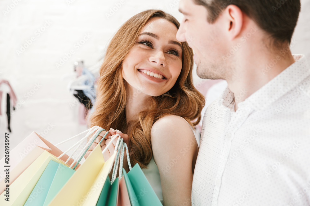 Close up of cheerful young couple shopping for clothes Close up of cheerful young couple shopping for clothes