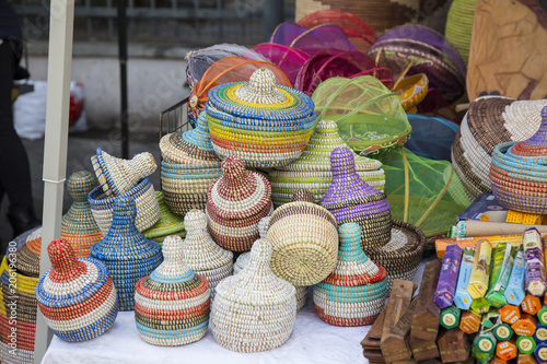Wallpaper Mural Display of small colorful hand woven baskets on a stall in a street market arranged in a jumble on a table in a close up view Torontodigital.ca