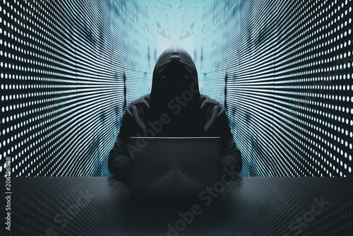 Anonymous hacker in front of his computer