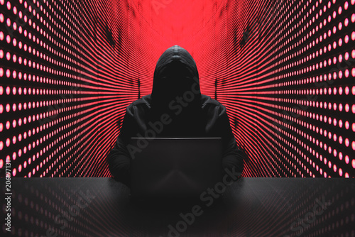Anonymous hacker in front of his computer photo