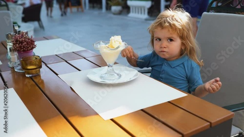 Kids enyoj happy day. Happy kid having fun. Child Childhood Children Happiness Concept. Sweet toddler boy eating ice cream.