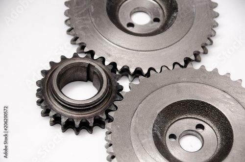 A gear wheel or pinion is a basic part of a gear train in the form of a disc with teeth on a cylindrical or conical surface meshing with the teeth of another gear