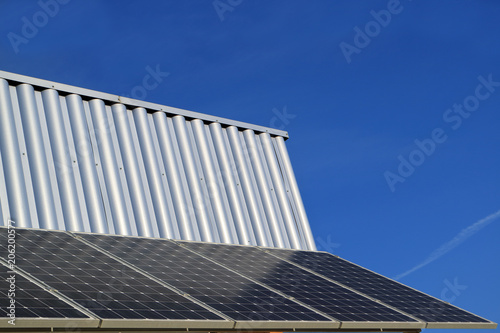 Image of the solar battery on the wall against the sky.