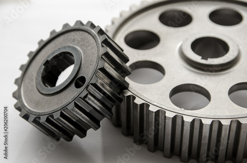 A gear wheel or pinion is a basic part of a gear train in the form of a disc with teeth on a cylindrical or conical surface meshing with the teeth of another gea photo