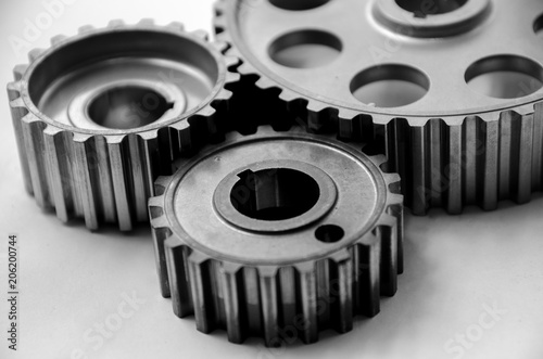 A gear wheel or pinion is a basic part of a gear train in the form of a disc with teeth on a cylindrical or conical surface meshing with the teeth of another gear