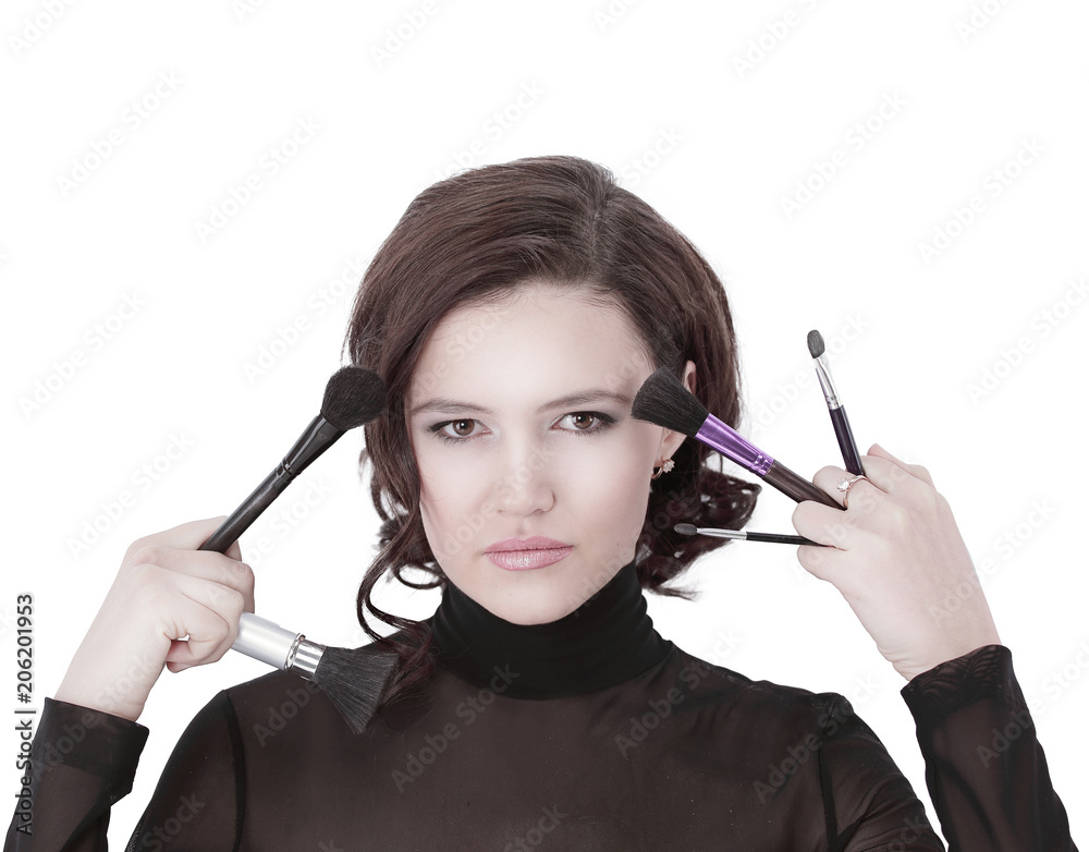 Obraz premium beautiful young woman holding make-up brushes